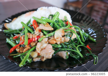 stir fried morning glory or stir fried vegetable with rice and sunny side up egg or Thai food stir fried morning glory or stir fried vegetable with rice and sunny side up egg or Thai food 98223005