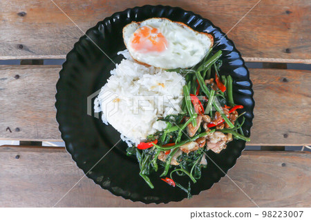 stir fried morning glory or stir fried vegetable with rice and sunny side up egg or Thai food stir fried morning glory or stir fried vegetable with rice and sunny side up egg or Thai food 98223007
