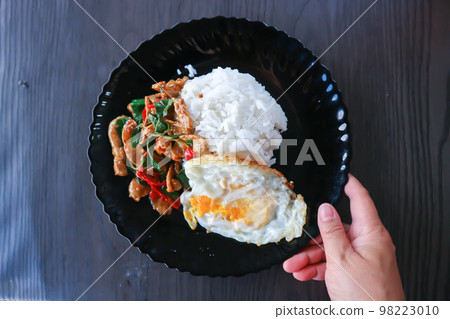 stir fried pork with chili, holy basil and rice with sunny side up egg stir fried pork with chili, holy basil and rice with sunny side up egg 98223010