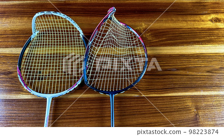 Close up broken badminton racket on brown wooden background Close up broken badminton racket on brown wooden background 98223874