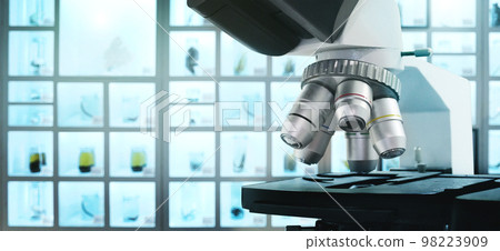 Microscope for science lab or research to expand view on the background Microscope for science lab or research to expand view on the background 98223909