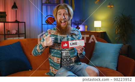 Happy young man looking approvingly at camera showing thumbs up, like positive sign, good news 98223952