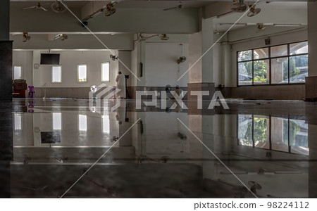 Religious muslim man is standing praying inside the mosque. The muslim prayer for god in the mosque. 98224112