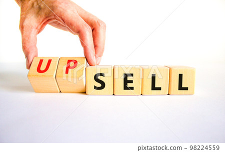 Sell or upsell symbol. Concept word Sell Upsell on wooden cubes. Businessman hand. Beautiful white table white background. Business Sell or Upsell concept. Copy space. 98224559