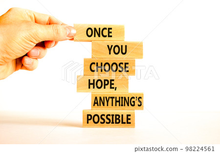 Hope and anything is possible symbol. Concept words Once you choose hope anything is possible on wooden blocks on a beautiful white background. Businessman hand. Business and hope concept. Copy space. Hope and anything is possible symbol. Concept words Once you choose hope anything is possible on wooden blocks on a beautiful white background. Businessman hand. Business and hope concept. Copy space. 98224561
