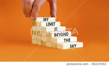 My limit is the sky symbol. Concept words My limit is beyond the sky on wooden blocks on a beautiful orange table orange background. Businessman hand. Business my limit is beyond the sky concept. 98224562