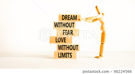 Dream and love symbol. Concept words Dream without fear love without limits on wooden blocks on a beautiful white table white background. Businessman icon. Dream and love without limits concept. 98224566