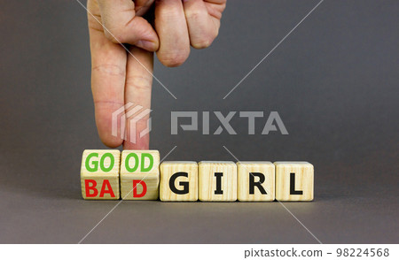 Good or bad girl symbol. Concept word Good girl Bad girl on wooden cubes. Businessman hand. Beautiful grey table grey background. Business psychological good or bad girl concept. Copy space. Good or bad girl symbol. Concept word Good girl Bad girl on wooden cubes. Businessman hand. Beautiful grey table grey background. Business psychological good or bad girl concept. Copy space. 98224568
