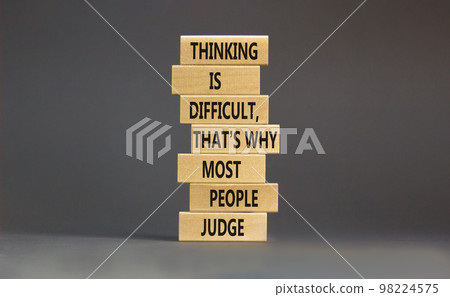 Thinking or judge symbol. Concept words Thinking is difficult that is why most people judge on blocks. Beautiful grey table grey background. Business thinking or judge concept. Copy space. Thinking or judge symbol. Concept words Thinking is difficult that is why most people judge on blocks. Beautiful grey table grey background. Business thinking or judge concept. Copy space. 98224575