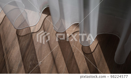Sheer white tulle curtains and wooden floor 98224577