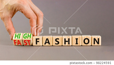 Fast or high fashion symbol. Concept words Fast fashion and High fashion on wooden cubes. Businessman hand. Beautiful grey table grey background. Business fast or high fashion concept. Copy space. Fast or high fashion symbol. Concept words Fast fashion and High fashion on wooden cubes. Businessman hand. Beautiful grey table grey background. Business fast or high fashion concept. Copy space. 98224591
