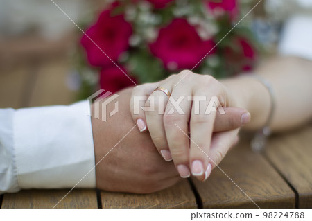 Marriage and love. Male and female hand with a wedding ring. 98224788