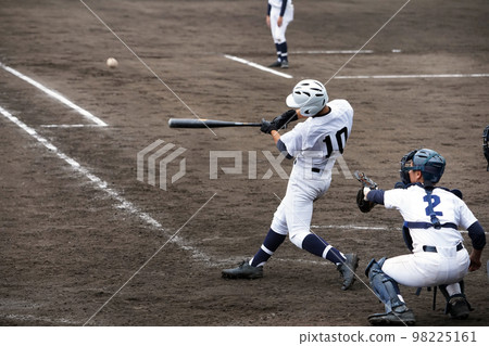 Left batter hitting a hit in a baseball game (high school baseball) Left batter hitting a hit in a baseball game (high school baseball) 98225161