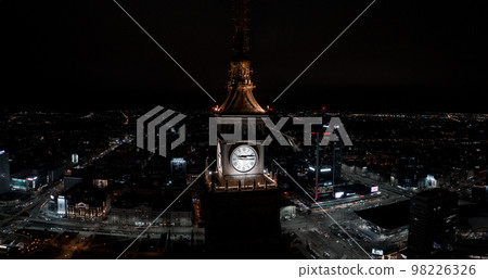 Aerial night view of the Palace of Culture and Science near downtown business skyscrapers in the city center. Aerial night view of the Palace of Culture and Science near downtown business skyscrapers in the city center. 98226326