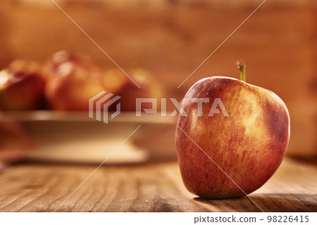 Red apple on wooden table Red apple on wooden table 98226415