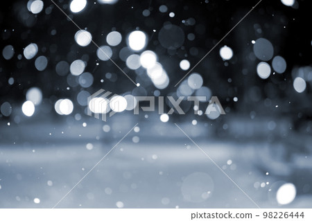 Blurred background. City view, lights, falling snow, night, street, bokeh spots of headlights of moving cars. Urban backdrop winter scenery of street in city night. Lantern light, snowfall. Blue color 98226444
