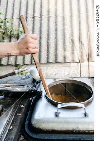 A man prepares lunch in a military field kitchen. A man prepares lunch in a military field kitchen. 98226470