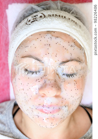 Close-up of a girl's face with an alginate mask, procedure at a cosmetologist. 98226486