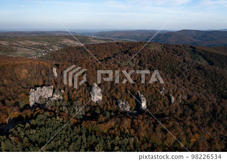 Dovbush rocks and a view of them from a height, a photo of Dovbush rocks from a drone in autumn. Dovbush rocks and a view of them from a height, a photo of Dovbush rocks from a drone in autumn. 98226534
