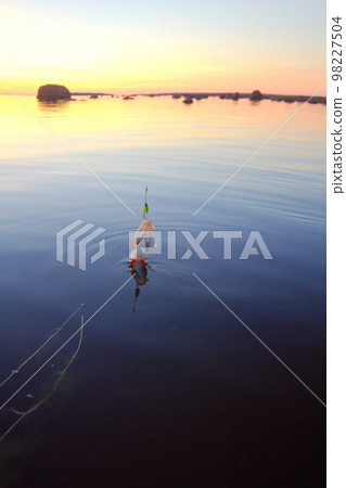 Sunset river perch fishing with the boat and a rod Sunset river perch fishing with the boat and a rod 98227504