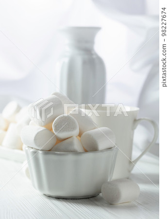 White marshmallows on a wooden table. 98227674