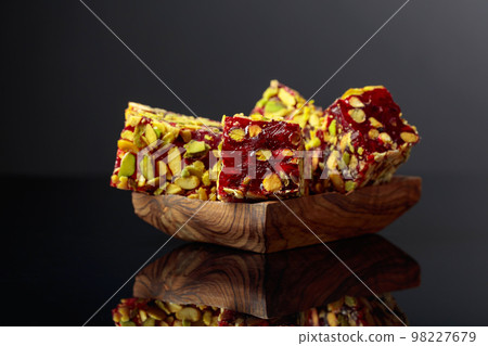 Traditional Turkish delight in a wooden dish. 98227679