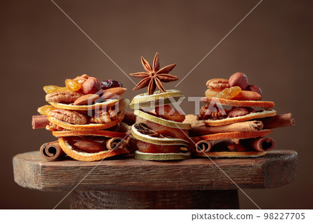 Christmas still-life with dried fruits, nuts, and spices. 98227705
