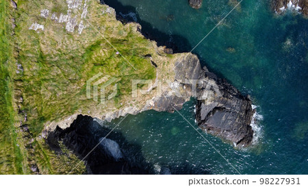 Grassy cliffs on the Atlantic Ocean coast. Landscape of Ireland from a height. Seaside rocks. Drone point of view. View from above. 98227931