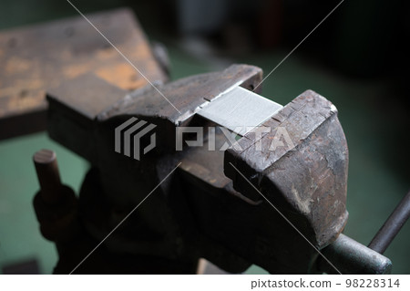 Where the stainless steel material is held in a vise 98228314