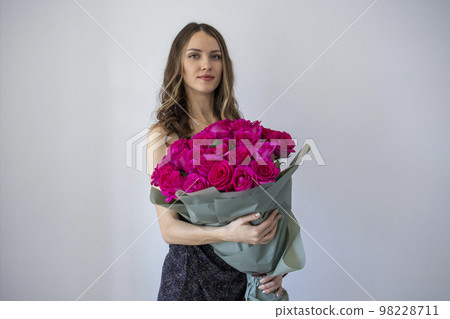 Girl holding a large bouquet of flowers 98228711