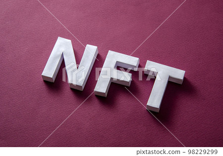 NFT text on a red background diagonally as a concept of modern technologies of online 98229299