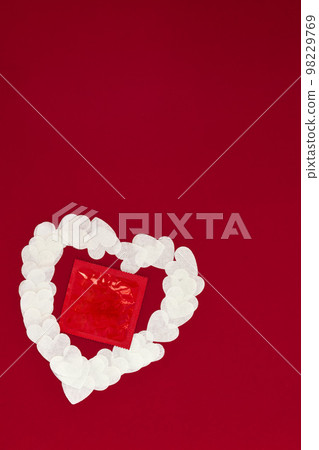 White Heart of papers and contraception on Viva Magenta background. White Heart of papers and contraception on Viva Magenta background. 98229769