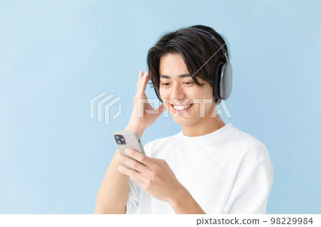 Male headphones music blue background 98229984