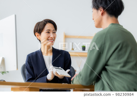 A woman appraising a watch A woman appraising a watch 98230984