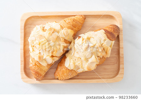 croissant with cream and almonds croissant with cream and almonds 98233660