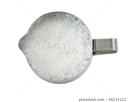 metallic pitcher with whipped milk isolated on white background, top view. 98234122