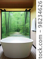 Relax bathtub with natural view in bathroom 98234626