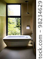 Relax bathtub with natural view in bathroom 98234629