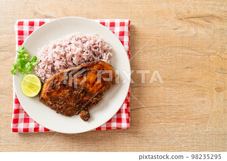 spicy grilled Jamaican jerk chicken with rice 98235295