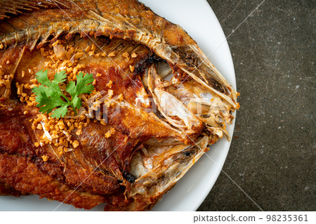 Fried Sea Bass Fish with Garlic 98235361