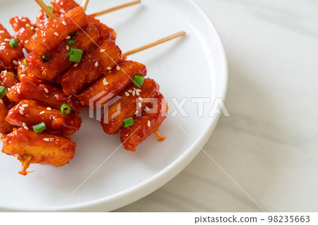 deep fried Korean rice cake (Tteokbokki) skewered with spicy sauce 98235663