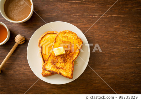 French toasted with butter and honey French toasted with butter and honey 98235829
