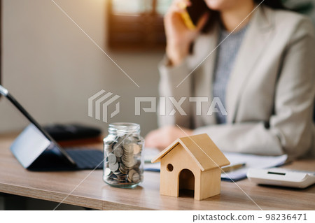 Salesman Hands On House Model , Small Toy House Small Mortgage Property insurance and concepts real estate. 98236471