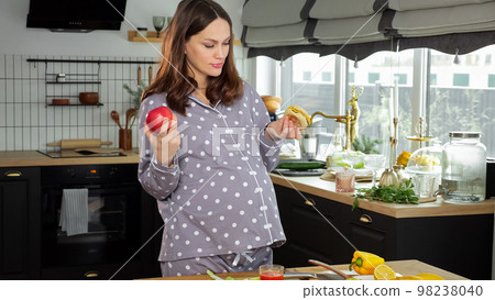Pregnant woman explores food and chooses yummy sandwich Pregnant woman explores food and chooses yummy sandwich 98238040