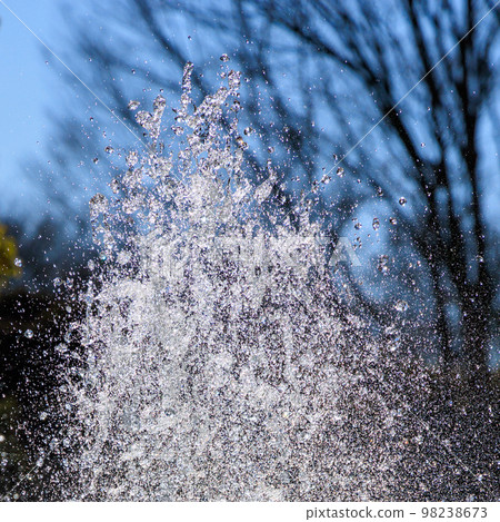 Splashes of a fountain in a winter park Splashes of a fountain in a winter park 98238673
