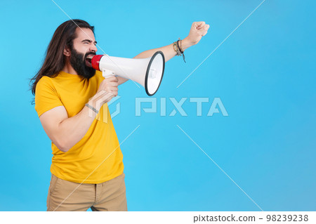 Man protesting while shouting with a loudspeaker Man protesting while shouting with a loudspeaker 98239238