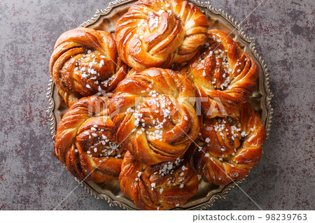 Homemade tasty Kanelbulle the nordic cinnamon rolls close-up on a plate. Horizontal top view 98239763