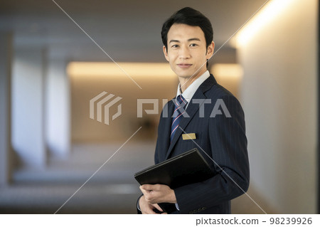 Businessman in his 30s looking at the camera front staff concierge image Businessman in his 30s looking at the camera front staff concierge image 98239926