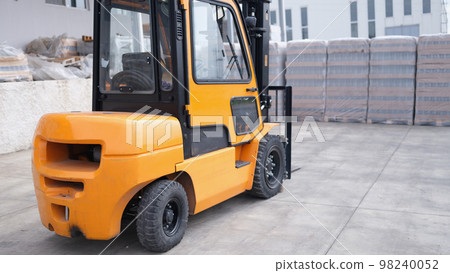 Parking forklift in logistics warehouse. Pallet stacking equipment outside and modern warehouse storage 98240052