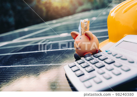 Piggybank on solar panel concept of money saved by using clean energy Piggybank on solar panel concept of money saved by using clean energy 98240380